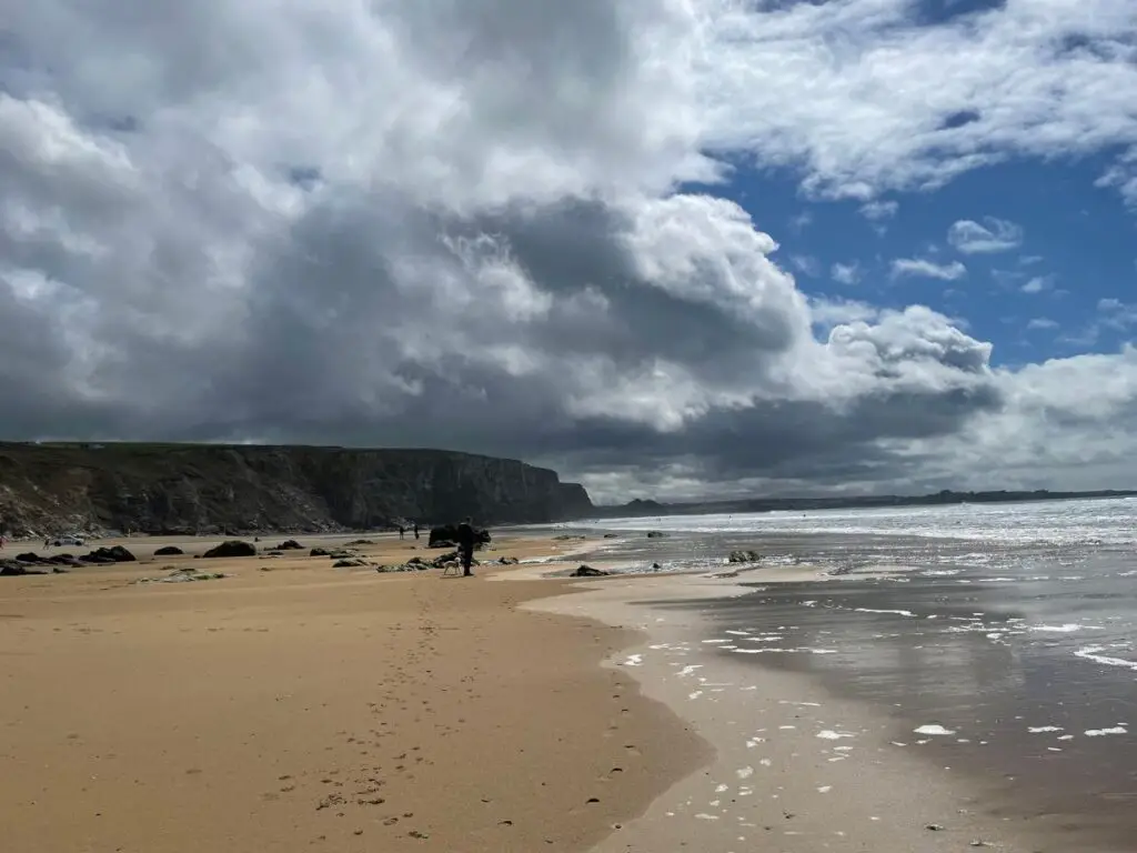 watergate bay beach with dark clouds